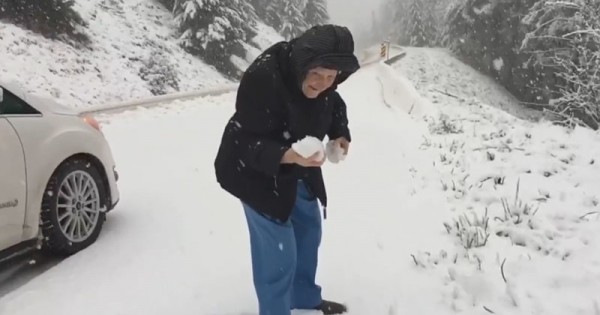 Old Woman Playing With Snow
