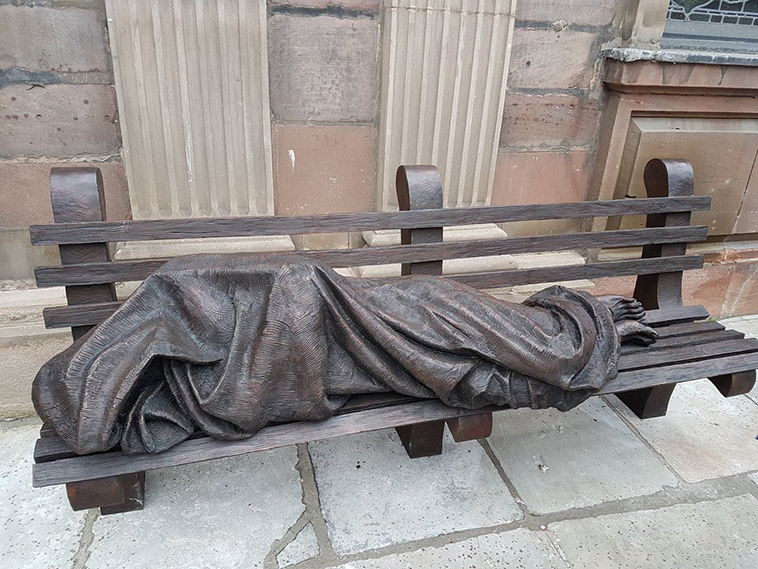 The Homeless Jesus statue in St. Ann's Square, Manchester