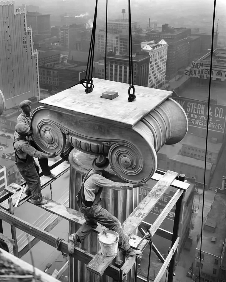 Laborers installing a Greek Ionic column at the Civil Courts Building