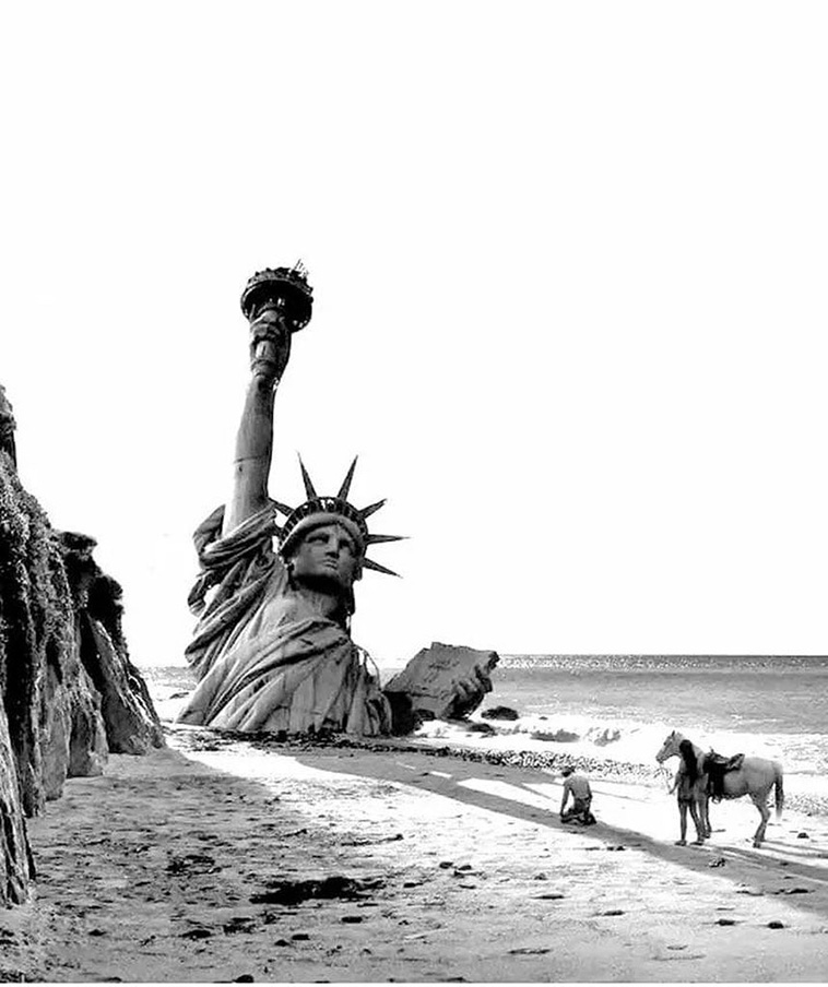 destroyed statue of liberty in the post-apocalyptic earth