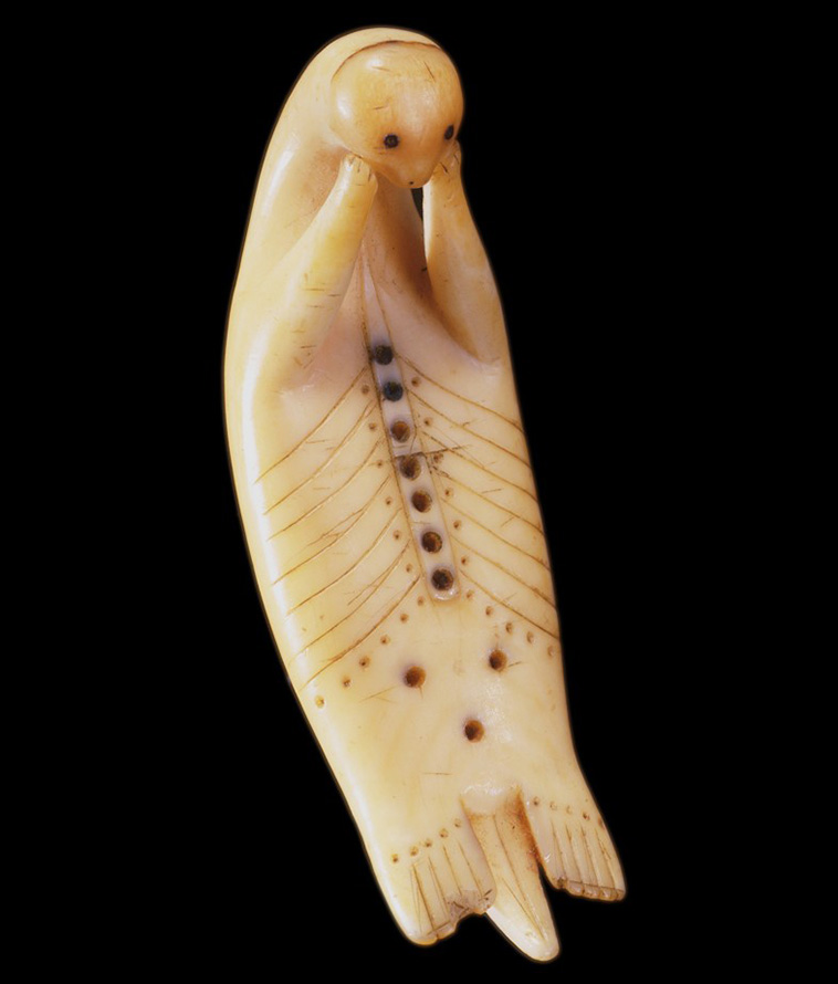 historical artifacts, An Inuit otter amulet carved out of pigmented ivory, c.1870-1880.