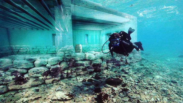 diver swimming in the ruins