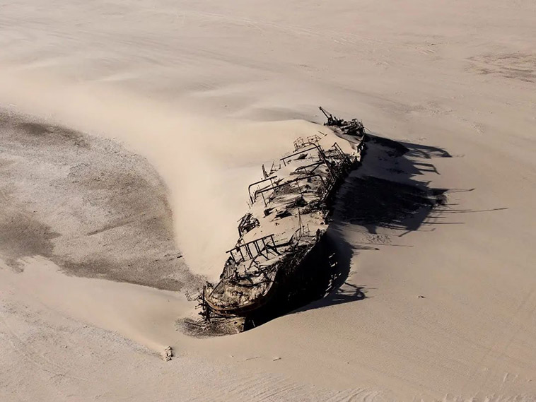 shipwreck buried under sand on skeleton coast